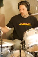 Darin pounding the drums at the Polar Bear Lair 2006 Budgie | Cirith Ungol Online